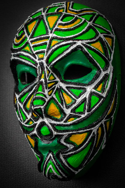 Masque artisanal vert avec motifs peints à la main.